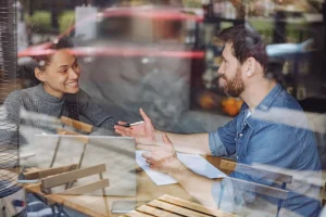 Brand Messaging: Say What You Do (work colleagues discussing business at a table)