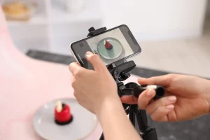 Social Media Marketing Budget in South Africa (person photographing a product with their cellphone in a semi-professional studio)